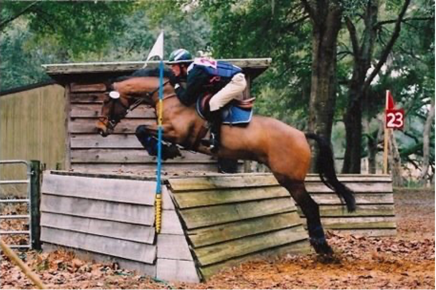 Schwartz jumping over cross-country obstacles with his horse, Trace