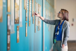 Amelia Bray-Aschenbrenner, MD, an assistant professor of pediatrics at Washington University School of Medicine in St. Louis, reads stories on the newly installed Desegregration History Wall on the Medical Campus.