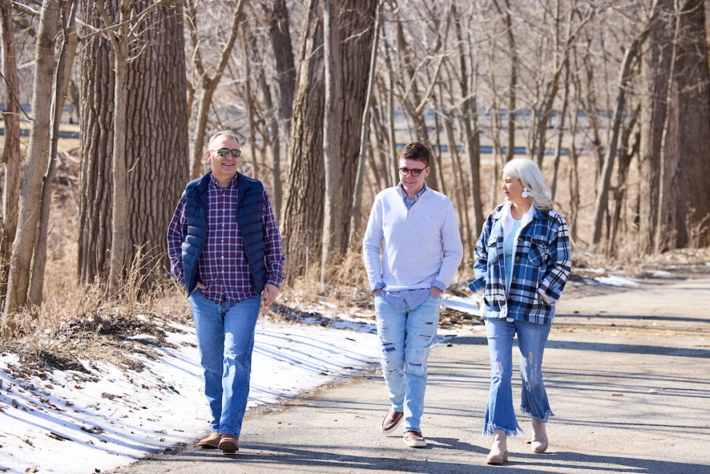 Ayden Isaacs, 15, (middle) walks along the Mississippi River in St. Louis County with his mother, Jennifer Isaacs, and his father, Michael Isaacs. Ayden Isaacs was diagnosed with DNMT3A Overgrowth Syndrome in 2015 at Washington University School of Medicine in St. Louis. Children and young adults with the rare genetic disease may have physical and intellectual disabilities and an increased risk for blood cancers, including acute myeloid leukemia (AML). Ayden’s clinical samples have helped researchers learn more about his condition and AML.